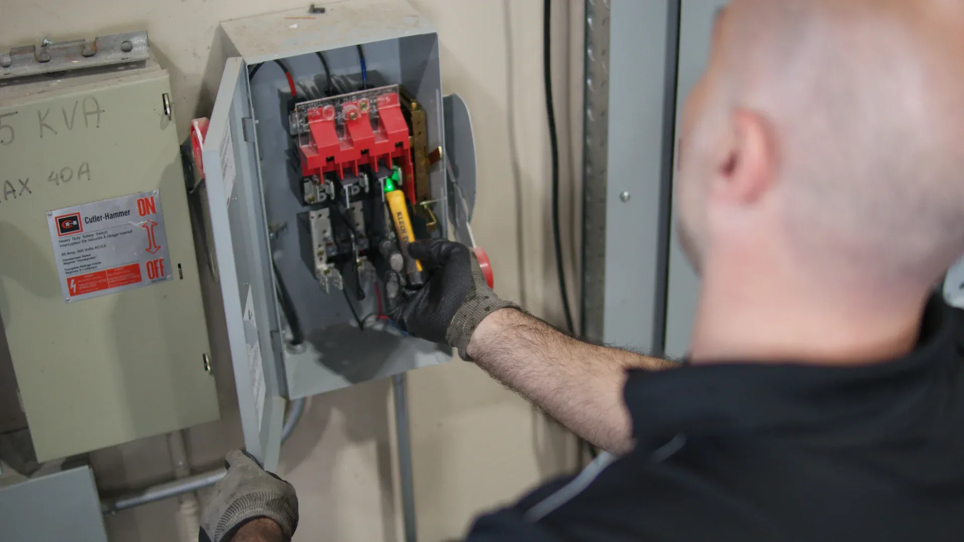 Electrician testing disconnect switch
