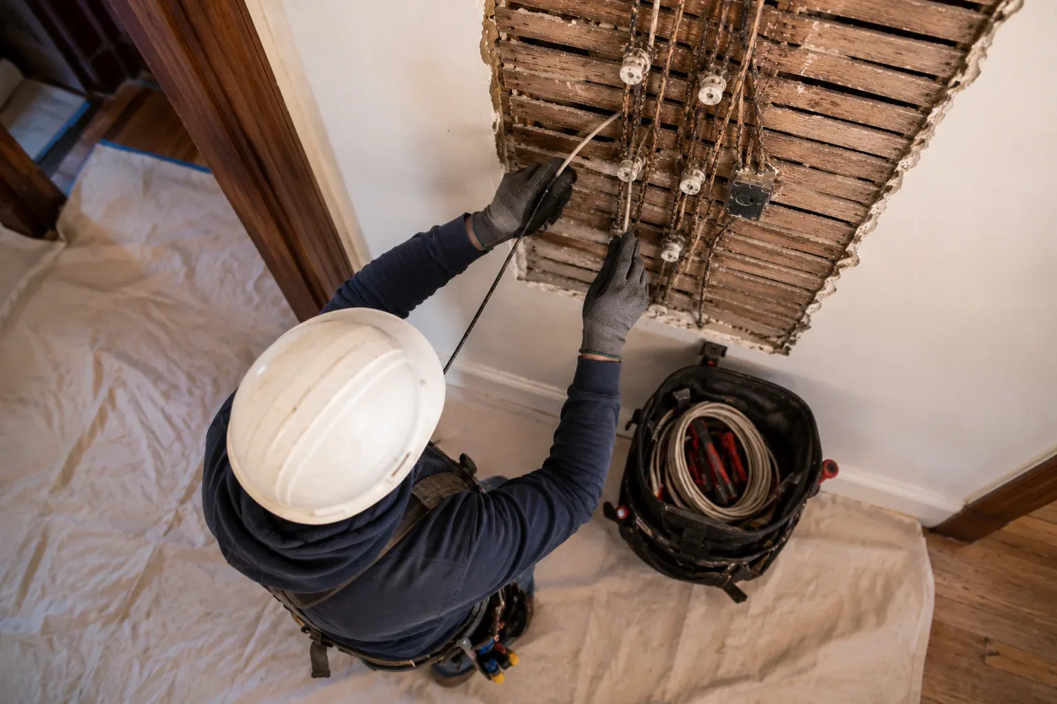Electrician replacing old wiring in a house