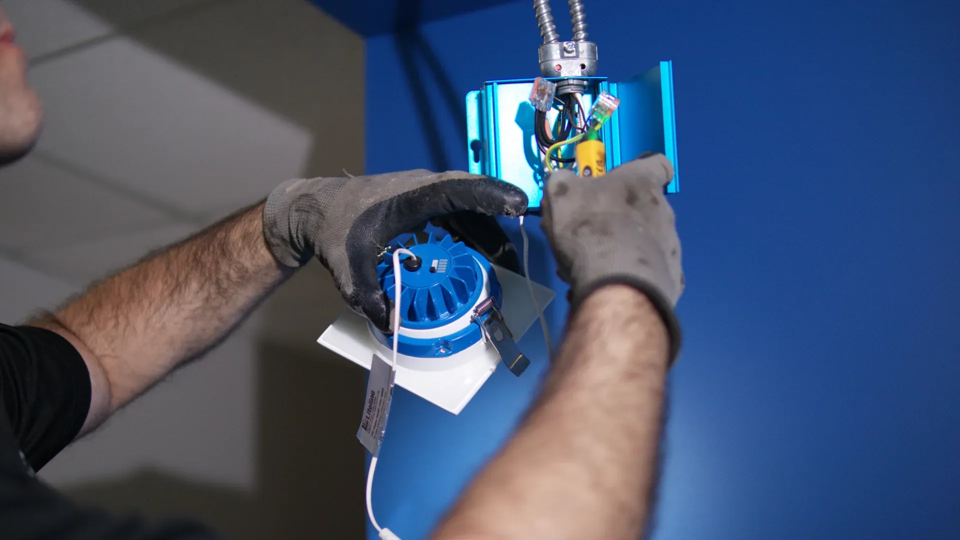 Electrician installing a recessed ceiling light