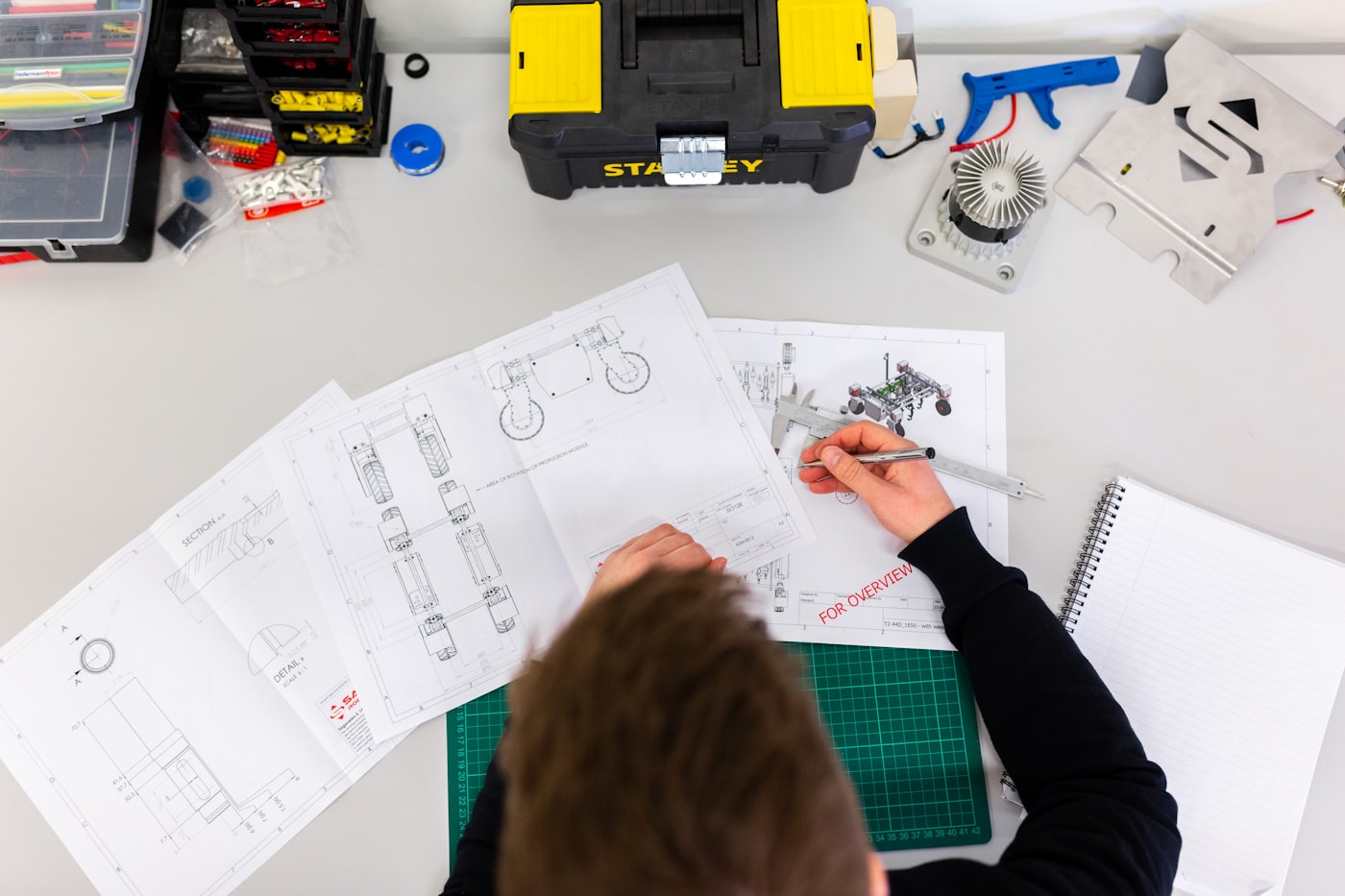 Engineer reviewing technical blueprints