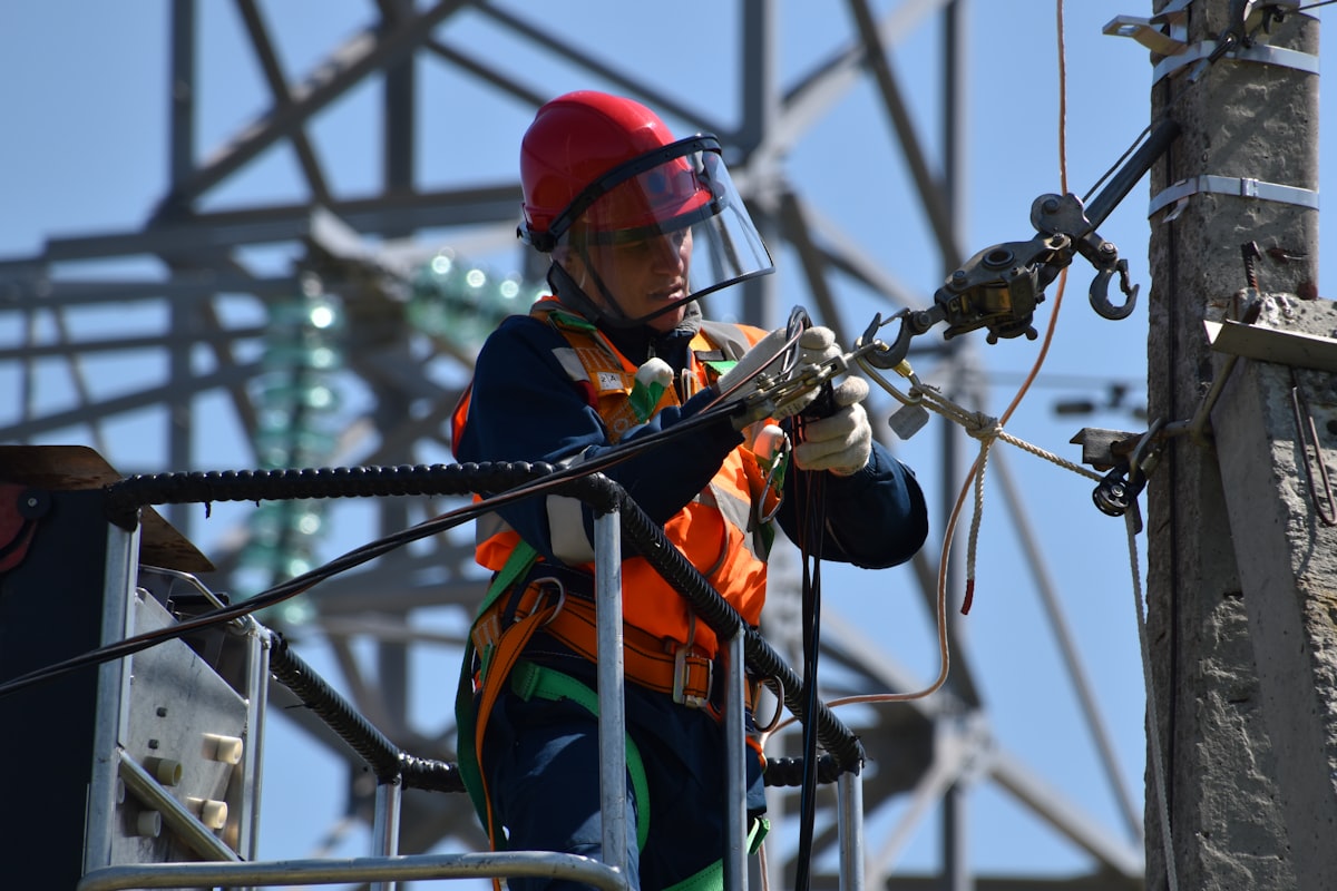Utility electrician maintaining overhead power lines